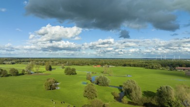 Aerial view of a beautiful green landscape with a small river flowing through. It is in the eastern