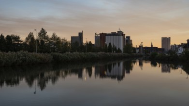 Wilsele, Flemish Brabant, Belgium, Reflection of industrial buildings in the canal during sunset