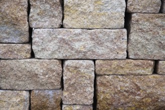 Rough stones layered as privacy screen and background - brown stone wall, pattern