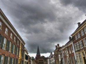Wide street view with historic houses and dramatic clouds in the sky, zutphen, gelderland,