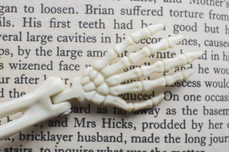 Skeletal hands book text. death, halloween and mistery concept