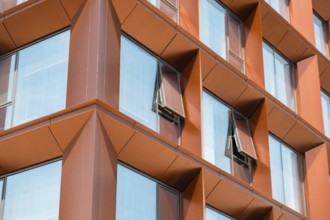 Modern office building exterior with glass facade on clear sky background. Transparent glass wall
