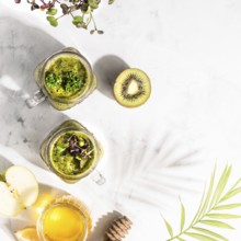 Food, Green detox cocktails in two cans, standing on a white table, top view, healthy lifestyle