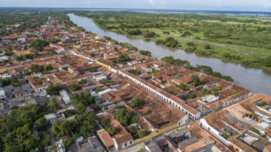 Aerial view of the historic town Santa Cruz de Mompox in sunlight with river and green