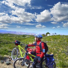 Cycling tourist MTB cyclist in Pedralba Valencia with paniers and saddlebag Spain