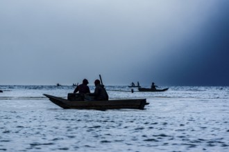 Tourists on a mooring enjoying the sunset, Lake Atitlan and San Pedro volcano, Santiago Atitlan,