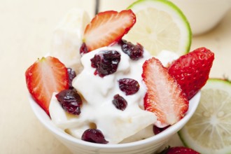 Fruit and yogurt salad healthy breakfast over white wood table, Food photography, Food photography