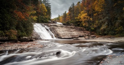 Triple Falls waterfall in fall color forest in the Appalachian mountains of North Carolina