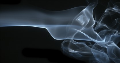Smoke of Cigarette rising against Black Background