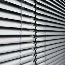 Venetian blind as sun protection on the window of a B