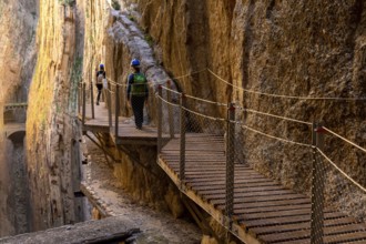 El Chorro, Spain - 22 February, 2022: tourists enjoy hiking the Camino del Rey on a bautiful winter