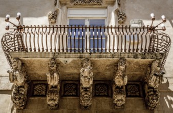 Noto town in Sicily, the Baroque Wonder - UNESCO Heritage Site. Detail of Palazzo Nicolaci balcony,