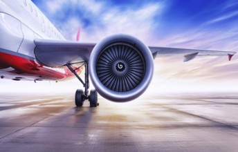 turbine of an airliner against a sunset