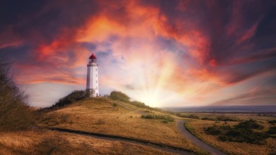 Lighthouse on the island of Hiddensee at sunset with a dramatic sky