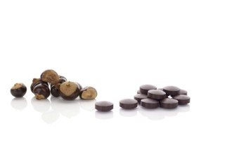 Guarana seeds and guarana pills isolated on white background. Medical Guarana dietary supplement