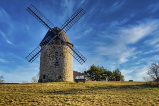 A windmill in the field in the daytime