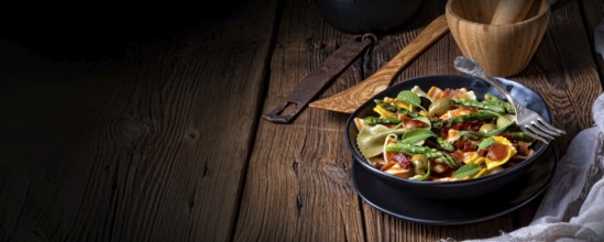 Pasta salad with green asparagus, olives and Parma ham