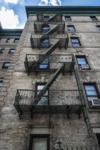 Traditional fire escape ladders at the facade of a New York's apartment, USA