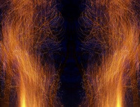 Flying sparks as abstract imression with symmetrical composition in front of a blue-black