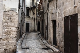 Old ancient typical alleyway in the Italian town of Trani, Southern Italy