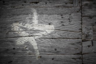 White star painted on the old cracked wood with worn-out paint. Grunge look