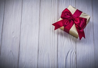Wrapped giftbox on wooden board holidays concept