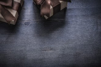 Wrapped gift containers on vintage wood board holiday concept