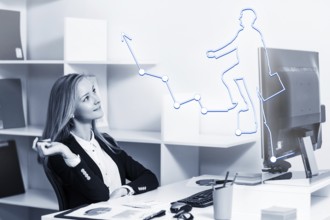 Young pretty business woman sitting at the desk with computer in blue office