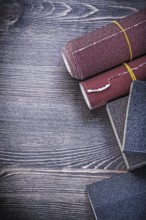 Rough abrasive paper sponges on vintage wood board construction concept