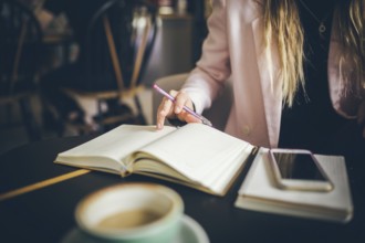 Business, education concept. Woman working in outdoor at coffee shop. Close up caucasian woman hand