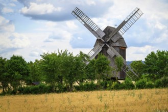 A view of a beautiful windmill in Thuringia Germany in a natural setting and an eye catcher for