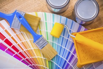 Set of painting tools paint brush roller tray can color palette on wooden desk
