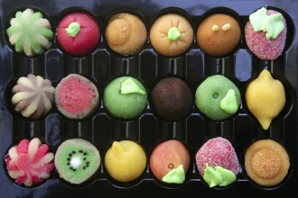 Colorful marzipan sweets with fruits shapes made of almond and sugar