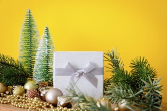 A Christmas decoration glass balls with fir trees on yellow background