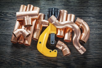 Plumbing copper water pipe cutter on wooden board
