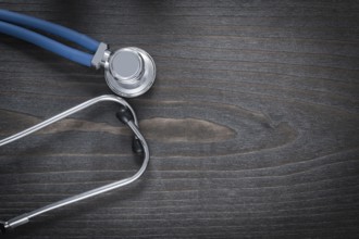 Wooden board with diagnostic medical stethoscope copy space image medicine concept