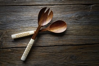Wooden kitchen tools spatules spoon and fork kitchenware on wooden background