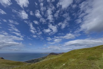 Vast rolling countryside with green meadows and sea views on the edge of Snowdonia National Park,