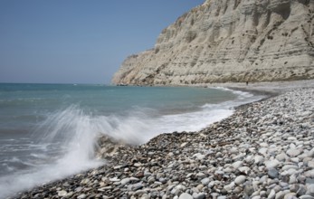 Empty pebble tropical beach under white cliffs against blue sky. Pissouri coastline Limassol Cyprus