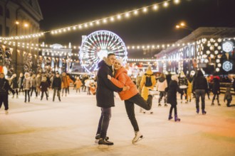 Couple hugging in Saint Valentine's Day. Young romantic couple having fun outdoors in winter. St