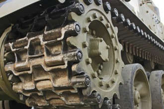 Part of the undercarriage of tracked military equipment, close-up