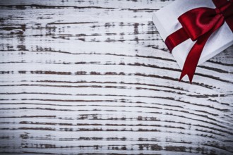 Present box on vintage wooden board copyspace holidays concept