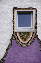 The close-up of a window which was decorated all around with glass splinters