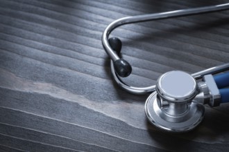 Wooden vintage board with blue medical stethoscope copy space image medicine concept