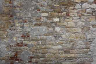 Rustic wall made of clay bricks brown and red