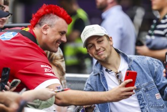 MELBOURNE, AUSTRALIA - MARCH 13: Liam Lawson of New Zealand and Oracle Red Bull Racing with fans