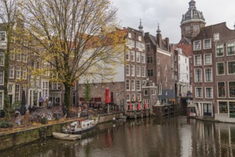 Historic buildings and boats on an Amsterdam canal in autumn, Amsterdam, Netherlands