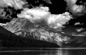 A dramatic black and white landscape with the Canadian Rocky Mountains and Emerald Lake under a