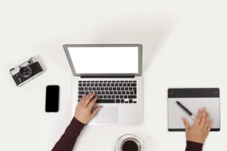 Clean and modern workplace. Notebook, coffee, graphic tablet, phone, camera and to do list and