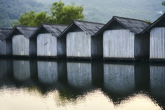 Row of houses on the river with reflections in the water